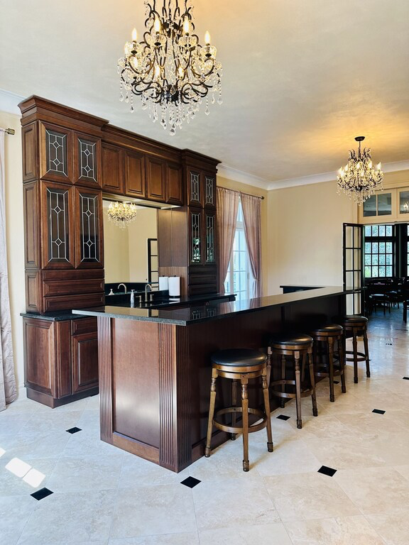 Sophisticated bar area with crystal chandeliers and marble floors