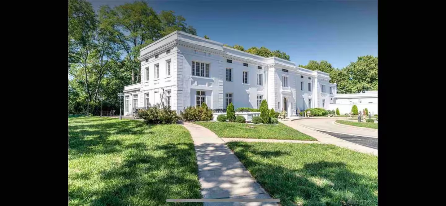 The Mansion exterior surrounded by lush greenery