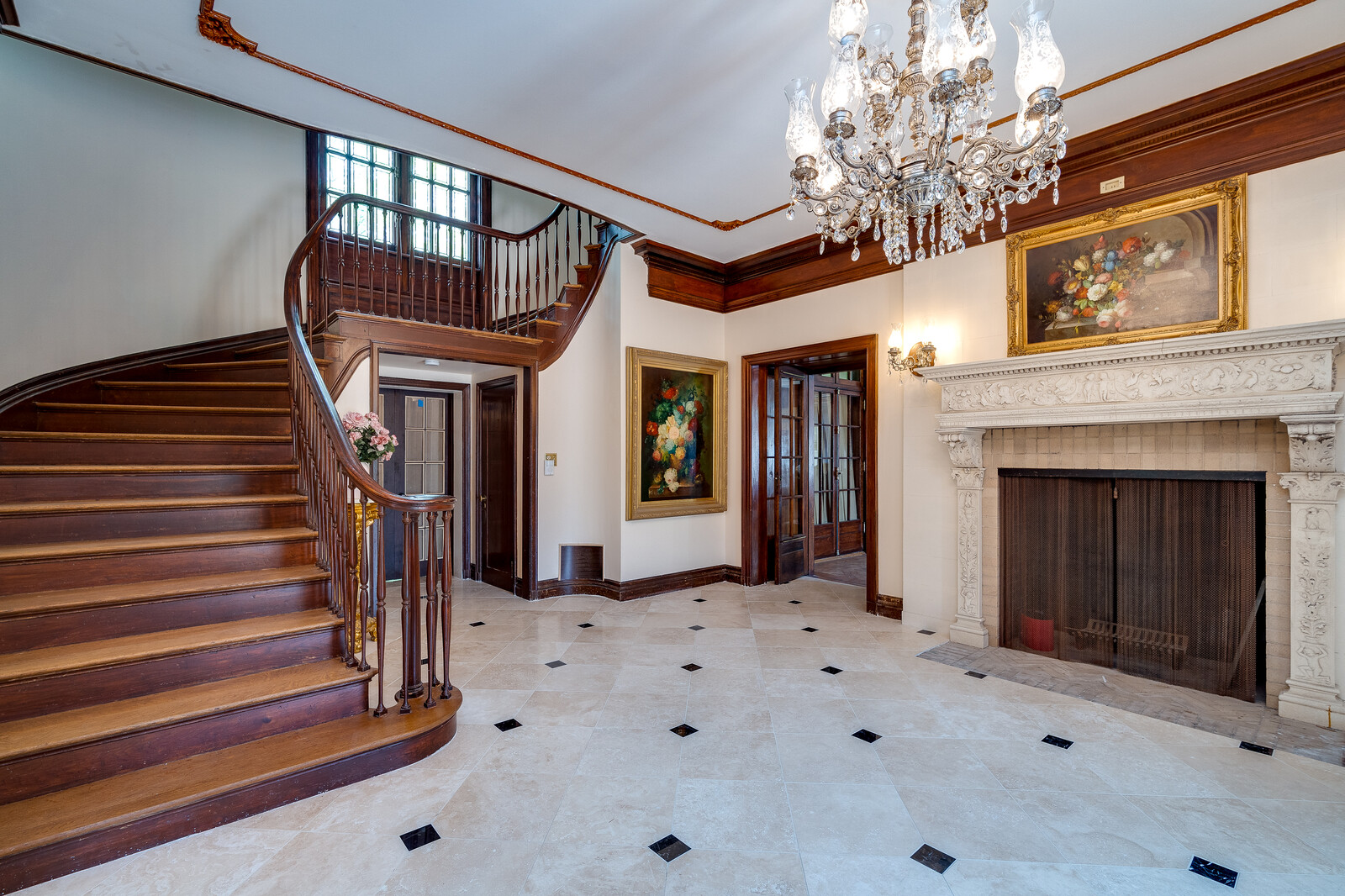 Grand foyer with sweeping staircase and crystal chandelier
