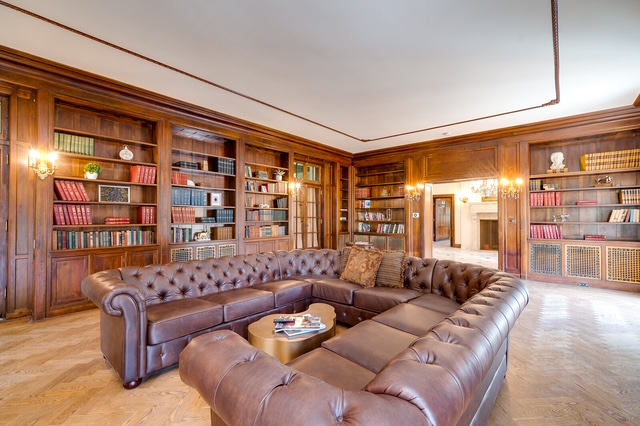 Elegant library lounge with leather seating and built-in bookshelves